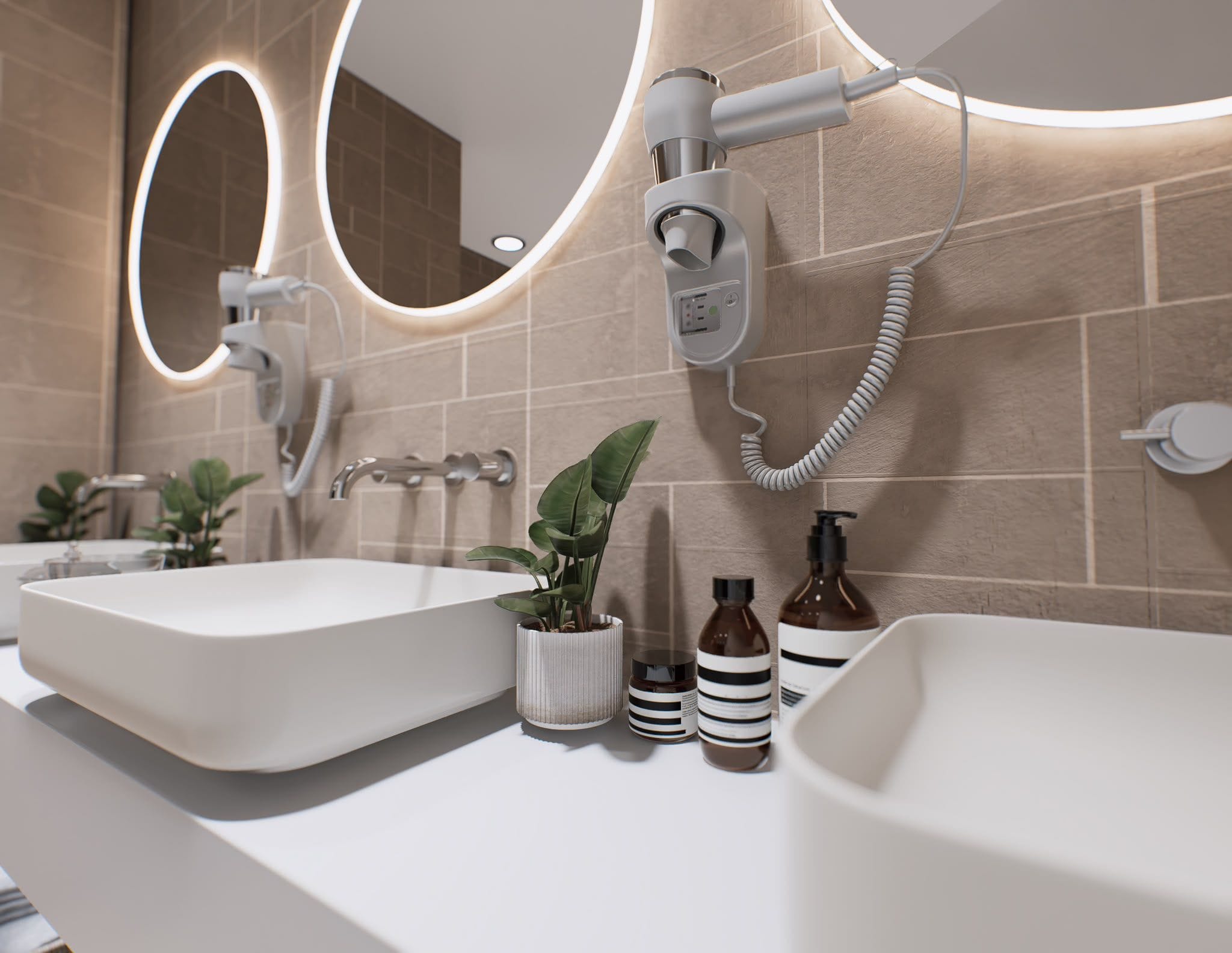 The changing rooms with round mirrors, twin basins and warm stone finishes